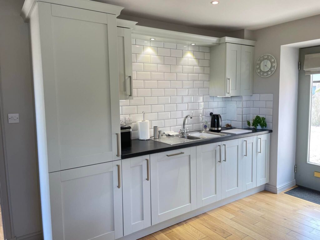 Transformed hananted kitchen with cupboards and sink in white